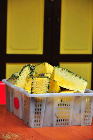 A basket of cut pineapplesの写真素材