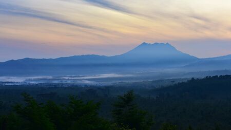 Sun rising behind the mountains in East Java, Indonesiaの写真素材