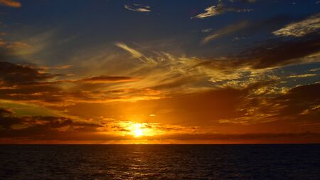 Sun setting above the Pacific Ocean, Kauai, Hawaiiの写真素材