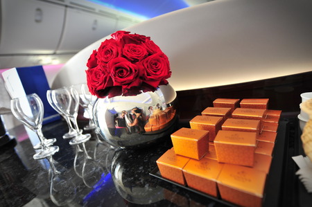 SINGAPORE - FEBRUARY 12: Flowers and chocolates to welcome passengers onboard the Qatar Airways Boeing 787-8 Dreamliner at Singapore Airshow February 12, 2014 in Singaporeのeditorial素材