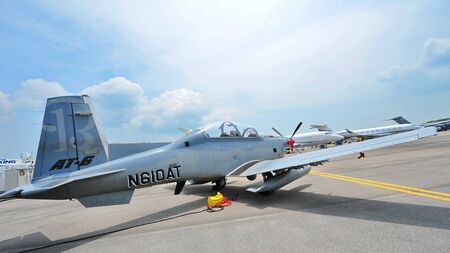 SINGAPORE - FEBRUARY 9: Beechcraft AT-6 Texan II light attack single turboprop plane on display at Singapore Airshow February 9, 2014 in Singaporeのeditorial素材