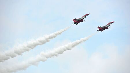 SINGAPORE - FEBRUARY 12: Republic of Singapore Air Force (RSAF) Black Knights performing aerobatics in their F-16 fighter jets at Singapore Airshow February 12, 2014 in Singaporeのeditorial素材