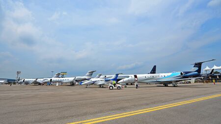 SINGAPORE - FEBRUARY 9: Various Embraer and Gulfstream executive jets on display at Singapore Airshow February 9, 2014 in Singaporeのeditorial素材