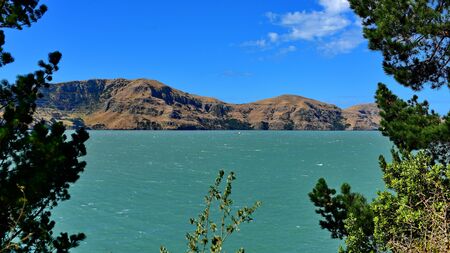 Scenic landscape of the sea and hills at Diamond Harbour in Canterbury, New Zealand