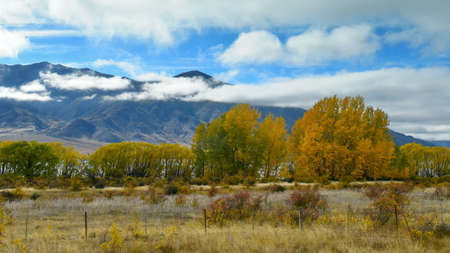 Scenic Lake Benmore and mountain ranges in the background during autumn in Canterbury, New Zealand