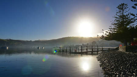 Jetty and scenic bays of Akaroa, Banks Peninsula in New Zealandの写真素材