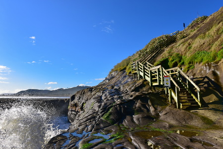 Stairs leading to the edge of Muriwai Beach in New Zealandの写真素材