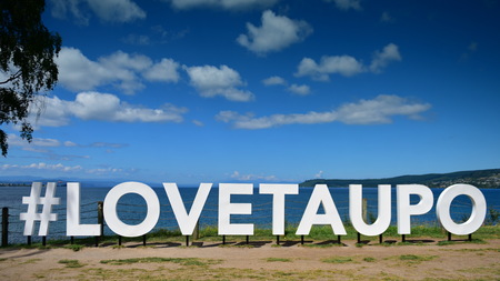 "#LOVETAUPO" sign next to Lake Taupo in North Island of New Zealandの写真素材