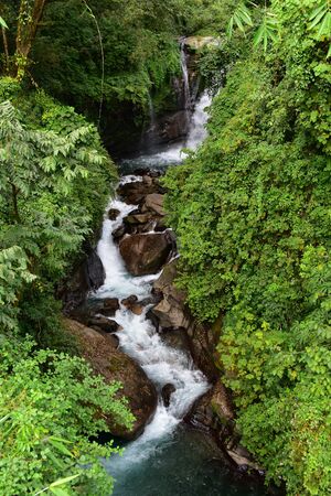 A beautiful waterfall along a hiking track in Nepalの写真素材