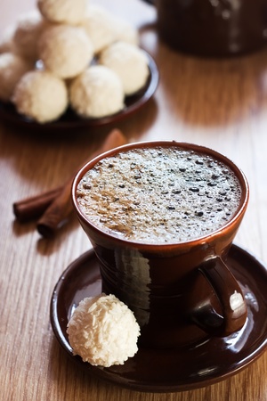 cup of coffee and white chocolate truffles on tableの写真素材