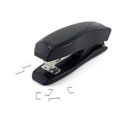 Office stapler isolated on white and some cramps nearの写真素材