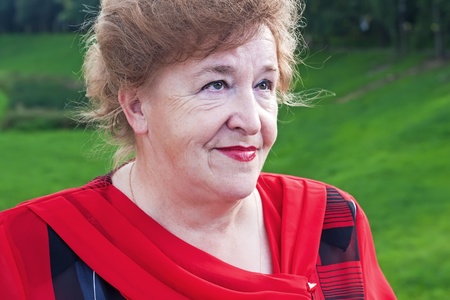 Closeup portrait of smiling elegant senior lady in redの写真素材