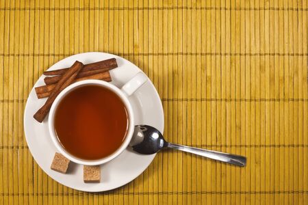 Tea with sugar and cinnamon on bamboo padの写真素材