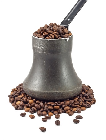 old coffee pot with coffee beans isolated on white の写真素材
