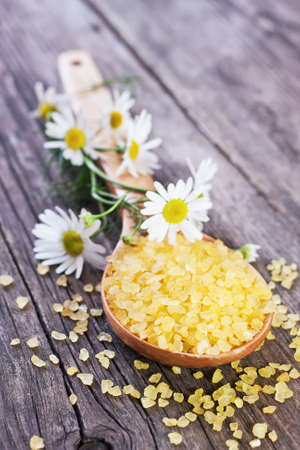yellow bath salt on wooden spoon, shallow focus 
の写真素材