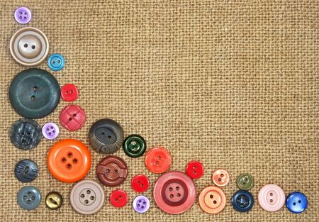 old colorful buttons on the background burlapの写真素材