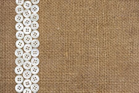 Nacre buttons on fabric texture background 