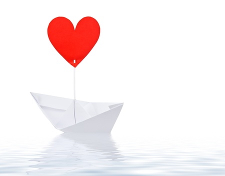 Paper ship with red heart sail on white backgroundの写真素材