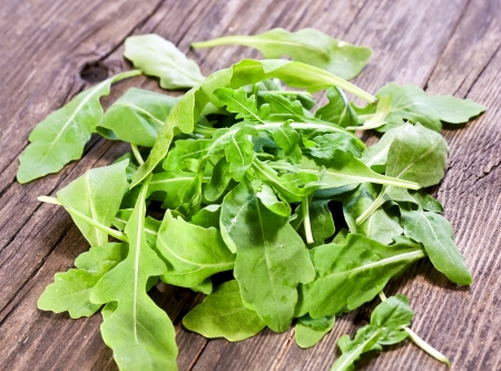 fresh arugula salad on wooden tableの写真素材