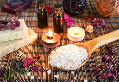 Spa with natural bath salt, candles, soap, towels and petalsの写真素材