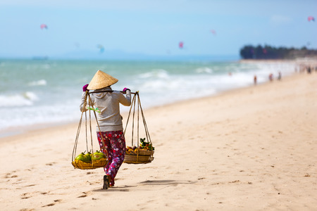 Vietnamese woman selling Fruits at Mui Ne beach. Vietnam. Asiaの写真素材