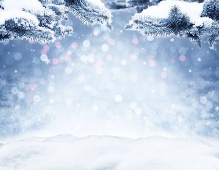 Winter decorative Christmas background with bokeh lights, snowflakes and empty old wooden table. Christmas and Happy New Year blue background with snowflake. Winter landscape with falling snow and fir tree branches.の写真素材