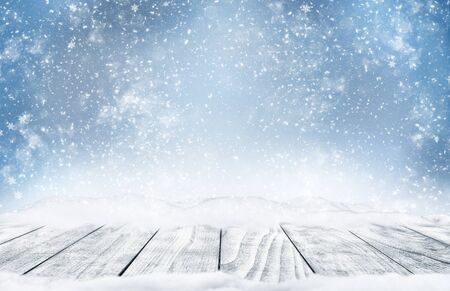 Decorative Christmas background with bokeh lights and snowflakes. Christmas and Happy New Year blue background with snowflake. Winter landscape with falling snow.の写真素材