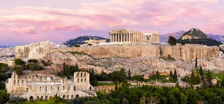 Panorama of Athens with Acropolis hill at dramatic sunset, Greece. The Acropolis of Athens located on a rocky outcrop above the city of Athens and contains the remains of several ancient buildings, the most famous being the Parthenon.の写真素材
