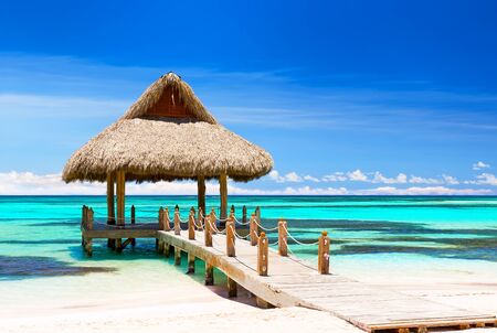 Beautiful gazebo on the tropical white sandy beach in Cap Cana, Dominican Republic.の写真素材