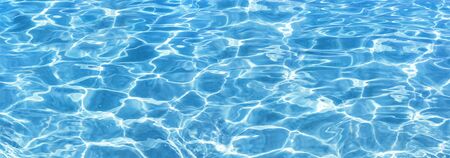 Shining blue water ripple background. Surface of water in swimming pool. Tropical beach water...