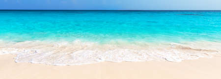 Panorama of wave of the sea on the sand beach in Punta Cana, Dominican Republic. Landscape of tropical summer. Summer beach vacation concept.の写真素材
