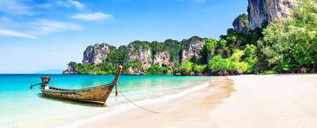Panorama of thai traditional wooden longtail boat and beautiful sand Railay Beach in Krabi province. Ao Nang, Thailand.の写真素材