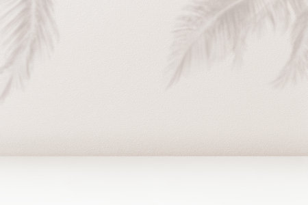 Product placement background with palm leaves shadow on beige cement wall texture. Empty palm shadow brown color pattern on wall background. Summer tropical beach concept.の写真素材