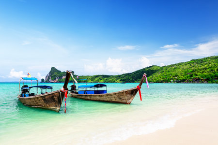 Thai traditional wooden longtail boat and beautiful sand beach at Koh Phi Phi island in Krabi province. Ao Nang, Thailand.の写真素材