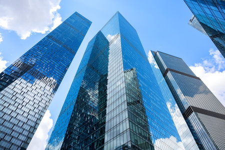 Modern glass silhouettes of skyscrapers in the city. Bottom view of modern skyscrapers in business district.の写真素材