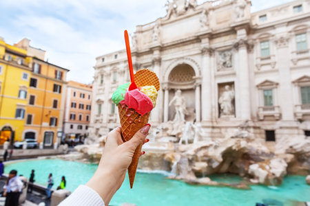 Italian ice cream gelato in front of amazing Trevi Fountain in Rome, Italy. Trevi Fountain or...