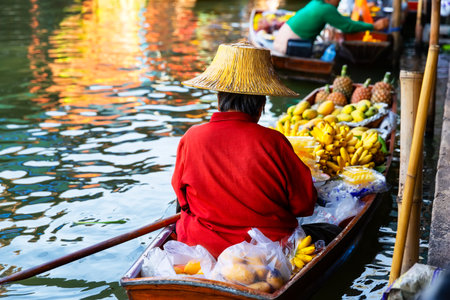 Traditional floating market in Damnoen Saduak near Bangkok in Thailand. Fruit seller at Damnoen Saduak floating market.の写真素材