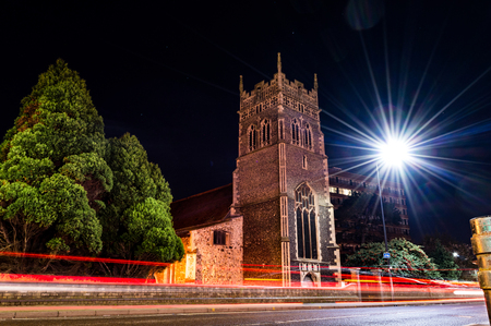 Long exposure night photography of a church and moving carsの写真素材