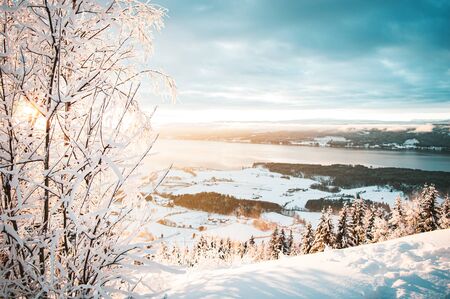 Sunrise, sunset picture in winter, in Scandinavia. Snowie mountains and trees. Travel photography,...