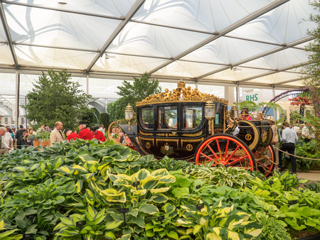 LONDON, UK - MAY 25, 2017: RHS Chelsea Flower Show 2017. Visitors observing the Australian State Coach and the Bowdens hostas in the Great Pavillion.のeditorial素材