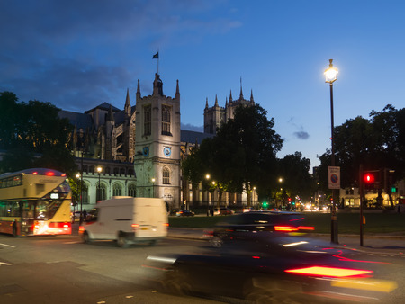 View of the Church of St Margaret with the Westminster Abbey in the background on Parliament Square, London all illuminated at dusk.の写真素材