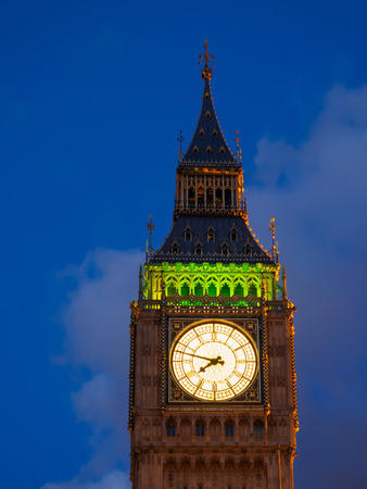 Closeup view of the illuminated Big Ben clock of the Elizabeth tower in London at dusk.の写真素材