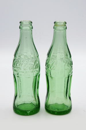 Vintage Coca Cola Bottle Made of Green Glass, White Backgroundのeditorial素材