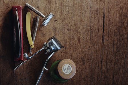 Vintage barber shop tools on wood texture background, Space for textの写真素材