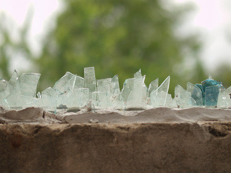 GLASS PIECES ON THE HOUSE FENCE FOR PROTECTION OF INTRUDERSの写真素材