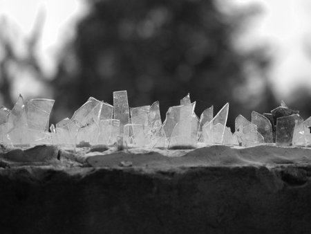 GLASS PIECES ON THE HOUSE FENCE FOR PROTECTION OF INTRUDERSの写真素材