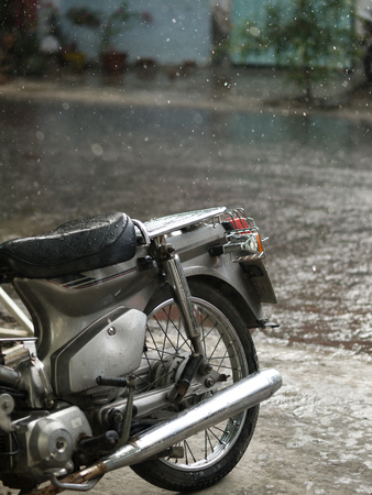 COLOR PHOTO OF MOTORCYCLE AND CLOSE-UP OF RAINDROPSの写真素材