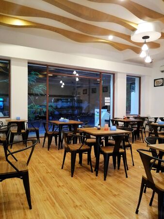 Cozy wooden interior of empty restaurant, copy space. Comfortable modern dining place, contemporary design backgroundの写真素材