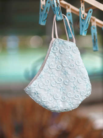 A hanged homemade cloth face mask made out of textile