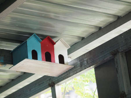 A colour photo of three colourful bird housesの写真素材